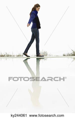 Woman walking at the poolside View Large Photo Image Stock Image - Woman walking at the poolside. Fotosearch