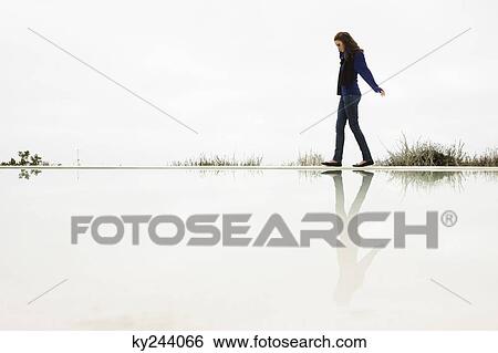 Woman walking at the poolside View Large Photo Image Stock Photograph - Woman walking at the poolside. Fotosearch