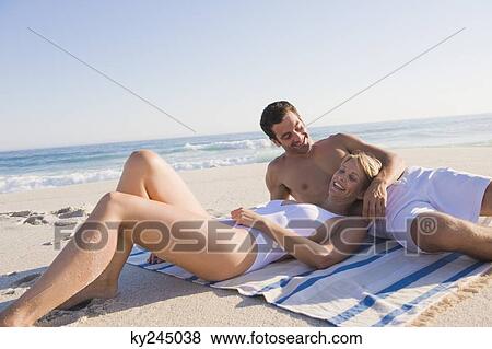 Couple lying on the beach View Large Photo Image Stock Photo - Couple lying on the beach. Fotosearch
