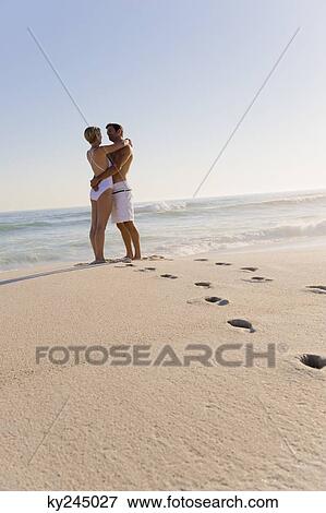 Stock Photo - Couple romancing on the beach. Fotosearch