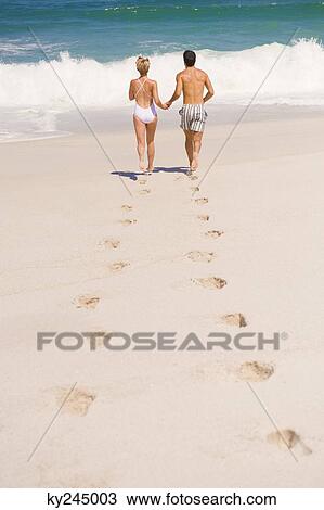 Couple running on the beach View Large Photo Image Stock Image - Couple running on the beach. Fotosearch