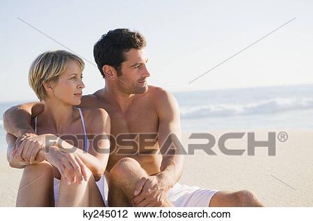 Couple sitting on the beach View Large Photo Image Stock Image - Couple sitting on the beach. Fotosearch