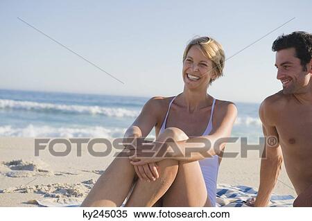 Couple sitting on the beach View Large Photo Image Stock Photography - Couple sitting on the beach. Fotosearch