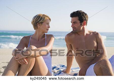 Couple sitting on the beach View Large Photo Image Stock Photography - Couple sitting on the beach. Fotosearch