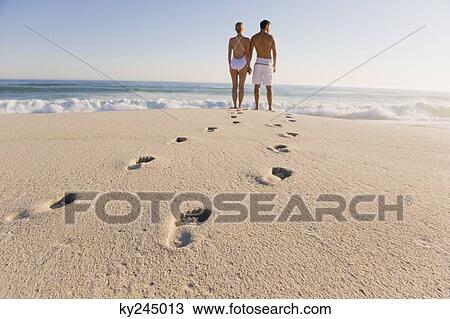 Couple standing on the beach View Large Photo Image Stock Image - Couple standing on the beach. Fotosearch