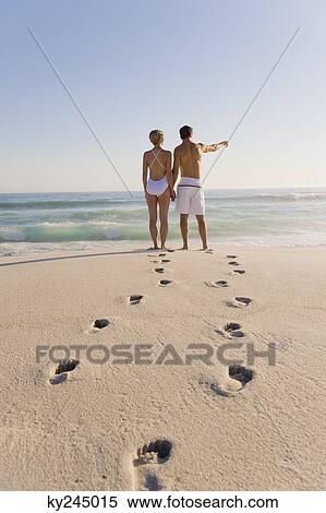 Couple standing on the beach View Large Photo Image Stock Photography - Couple standing on the beach. Fotosearch