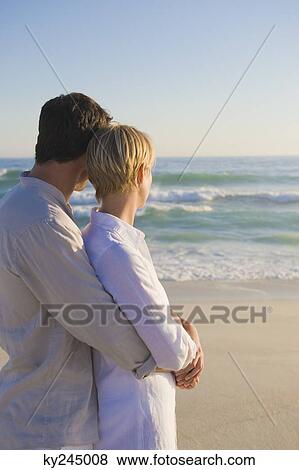 Man embracing a woman from behind View Large Photo Image Stock Photo - Man embracing a woman from behind. Fotosearch