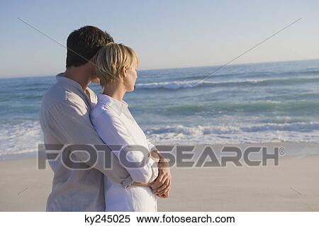 Man embracing a woman from behind View Large Photo Image Stock Photography - Man embracing a woman from behind. Fotosearch