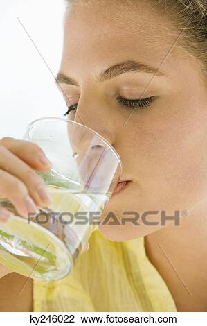 Close-up of a woman drinking lemonade View Large Photo Image Stock Image - Close-up of a woman drinking lemonade. Fotosearch