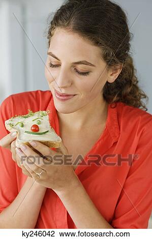 Stock Image - Close-up of a woman eating sandwich. Fotosearch