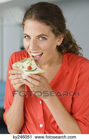 Portrait of a woman eating sandwich View Large Photo Image Stock Image - Portrait of a woman eating sandwich. Fotosearch