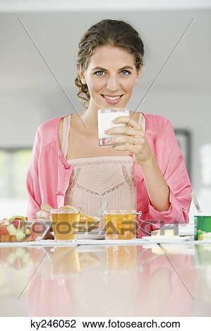 Portrait of a woman having breakfast View Large Photo Image Stock Image - Portrait of a woman having breakfast. Fotosearch