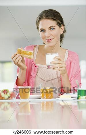 Portrait of a woman having breakfast View Large Photo Image Stock Photograph - Portrait of a woman having breakfast. Fotosearch