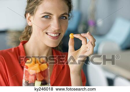 Portrait of a woman holding fruit salad View Large Photo Image Stock Photo - Portrait of a woman holding fruit salad. Fotosearch
