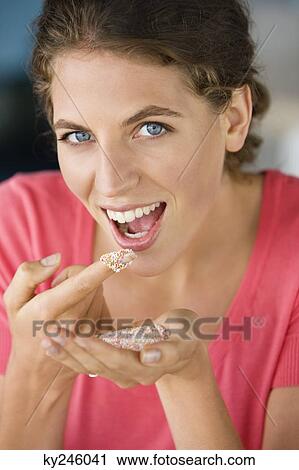 Woman eating colored sugar granules View Large Photo Image Stock Image - Woman eating colored sugar granules. Fotosearch