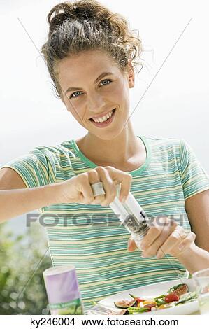 Woman seasoning salad View Large Photo Image Picture - Woman seasoning salad. Fotosearch