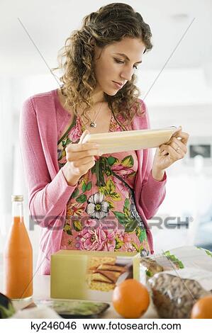 Woman working in the kitchen View Large Photo Image Stock Photograph - Woman working in the kitchen. Fotosearch