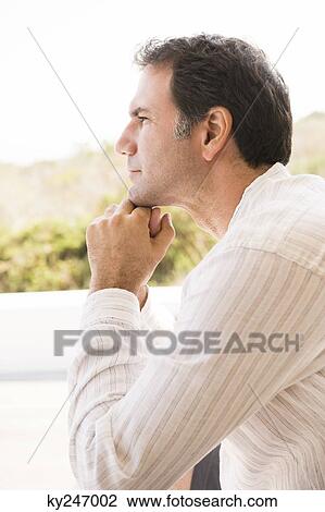Close-up of a man thinking View Large Photo Image Stock Image - Close-up of a man thinking. Fotosearch