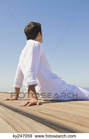 Man sitting on the beach View Large Photo Image Stock Photo - Man sitting on the beach. Fotosearch