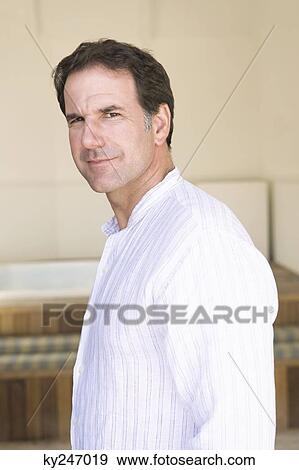 Portrait of a man smirking View Large Photo Image Stock Photo - Portrait of a man smirking. Fotosearch