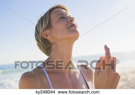 Close-up of a woman holding a perfume View Large Photo Image Picture - Close-up of a woman holding a perfume. Fotosearch