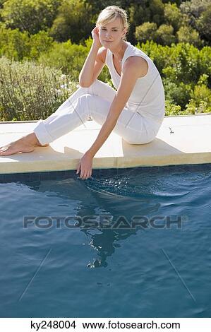 Portrait of a woman sitting at the poolside View Large Photo Image Picture - Portrait of a woman sitting at the poolside. Fotosearch