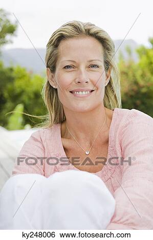 Portrait of a woman smiling View Large Photo Image Stock Photograph - Portrait of a woman smiling. Fotosearch