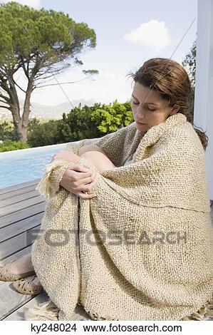 Woman resting on a wooden plank View Large Photo Image Picture - Woman resting on a wooden plank. Fotosearch