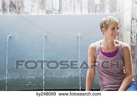Woman sitting in front of running water from faucets View Large Photo Image Stock Photo - Woman sitting in front of running water from faucets. Fotosearch
