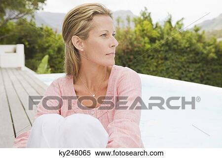 Woman sitting on a terrace View Large Photo Image Stock Photography - Woman sitting on a terrace. Fotosearch
