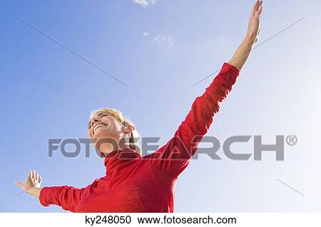 Woman stretching her arms and smiling View Large Photo Image Stock Image - Woman stretching her arms and smiling. Fotosearch