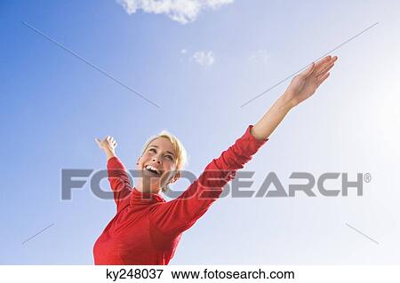 Woman stretching her arms and smiling View Large Photo Image Stock Photo - Woman stretching her arms and smiling. Fotosearch
