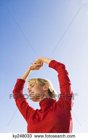 Woman stretching her arms View Large Photo Image Stock Image - Woman stretching her arms. Fotosearch