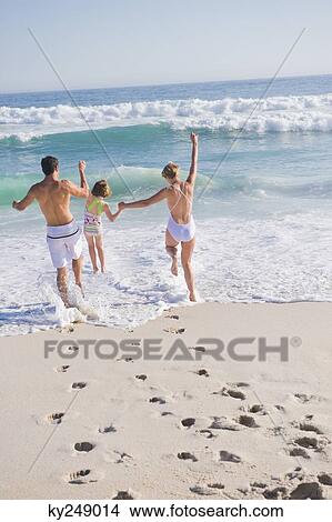 Family enjoying vacations on the beach View Large Photo Image Picture - Family enjoying vacations on the beach. Fotosearch