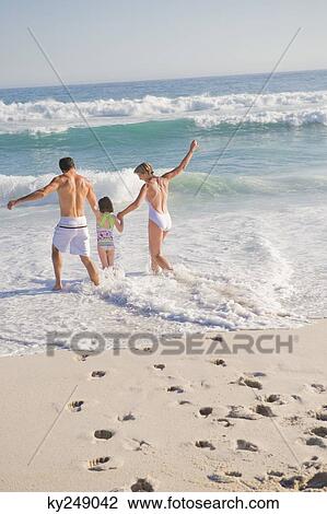 Family enjoying vacations on the beach View Large Photo Image Stock Image - Family enjoying vacations on the beach. Fotosearch