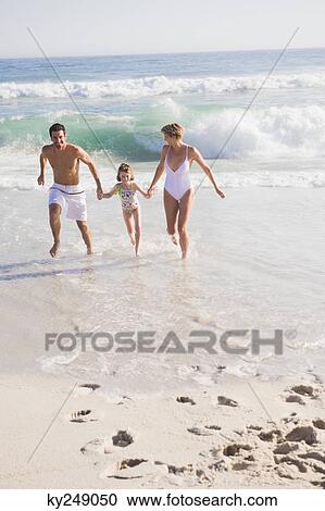 Family enjoying vacations on the beach View Large Photo Image Stock Image - Family enjoying vacations on the beach. Fotosearch