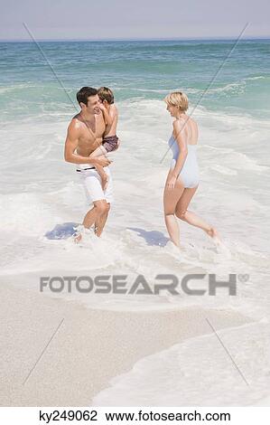 Family playing on the beach View Large Photo Image Stock Image - Family playing on the beach. Fotosearch