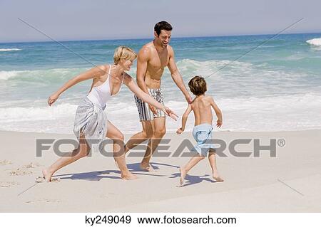 Family playing on the beach View Large Photo Image Stock Photo - Family playing on the beach. Fotosearch