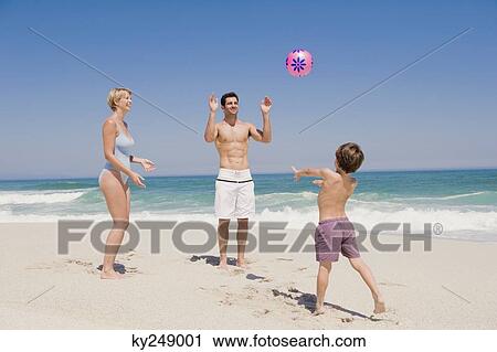 Family playing with a beach ball View Large Photo Image Stock Image - Family playing with a beach ball. Fotosearch
