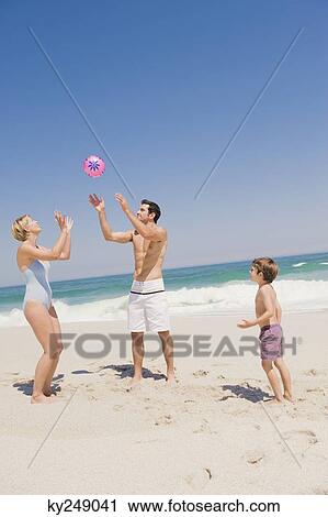 Family playing with a beach ball View Large Photo Image Stock Image - Family playing with a beach ball. Fotosearch