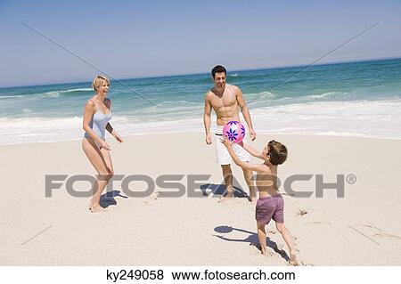 Family playing with a beach ball View Large Photo Image Stock Photo - Family playing with a beach ball. Fotosearch
