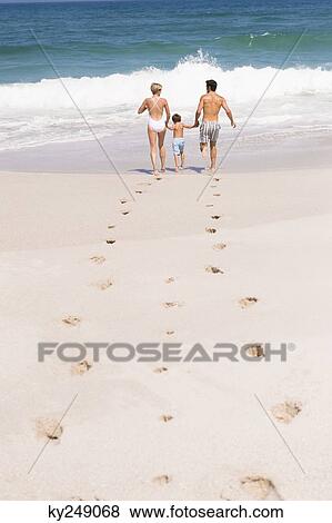 Family running on the beach View Large Photo Image Stock Photo - Family running on the beach. Fotosearch