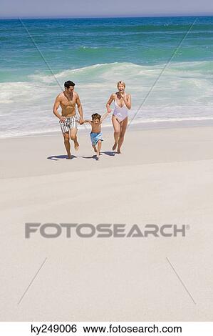 Family running on the beach View Large Photo Image Stock Photograph - Family running on the beach. Fotosearch