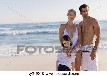 Family standing on the beach View Large Photo Image Stock Photo - Family standing on the beach. Fotosearch