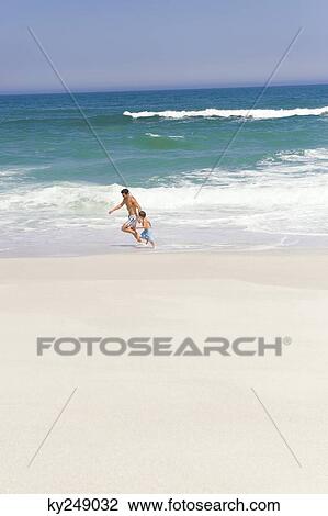 Man playing with his son on the beach View Large Photo Image Stock Image - Man playing with his son on the beach. Fotosearch
