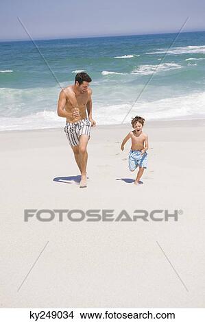 Man running with his son on the beach View Large Photo Image Picture - Man running with his son on the beach. Fotosearch