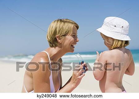Woman having fun with her daughter on the beach View Large Photo Image Stock Photo - Woman having fun with her daughter on the beach. Fotosearch