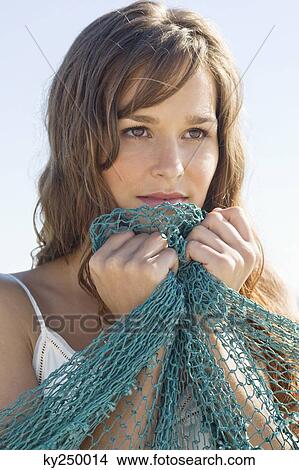 Close-up of a woman holding a net View Large Photo Image Picture - Close-up of a woman holding a net. Fotosearch