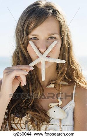 Portrait of a woman kissing a starfish View Large Photo Image Picture - Portrait of a woman kissing a starfish. Fotosearch