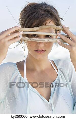 Woman peeking through sticks View Large Photo Image Stock Image - Woman peeking through sticks. Fotosearch